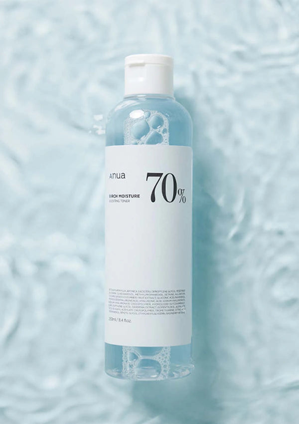 Bottle of skincare product with a label on a light blue textured background