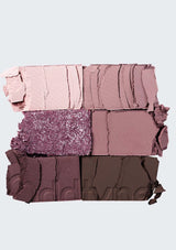 Makeup color swatches in shades of pink, purple, and brown on a light gray background