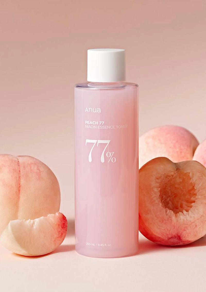 Pink bottle with white cap labeled '77%' surrounded by peach slices on a pink background