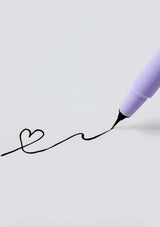 Purple pen writing a heart shape on a light gray background