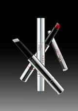 Lipstick and lip gloss set on a gradient black and gray background