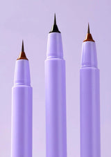 Three purple markers with metallic tips on a light purple background