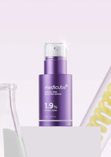 Purple skincare serum bottle with 'Medicube' branding on a light gray background