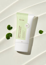 LUNIK Centella Calming Daily Sunscreen tube on a white background with green leaves.