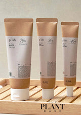 Three skincare cream tubes from 'p'tab' on a wooden tray with 'The Plant Base' branding.