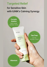 Hand holding a tube of IUNIK Centella Calming Gel Cream with product details on a gray background