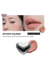 Lipstick with a heart-shaped cap on a white background, featuring a close-up of a person's lips wearing the lipstick.