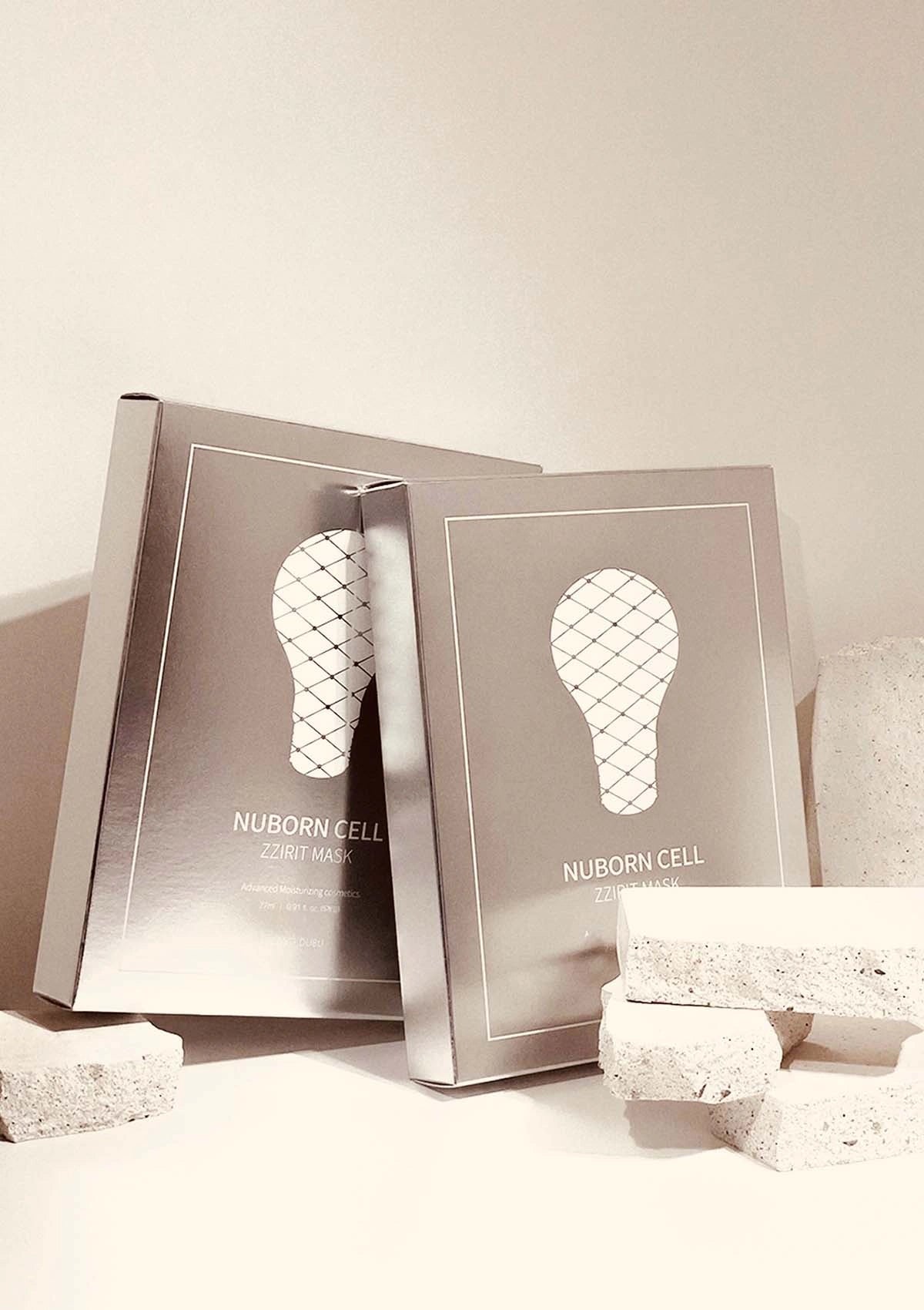 Two silver boxes with a light bulb design on a beige background