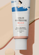 Tube of sunscreen with a decorative label on a beige background