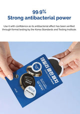 Hands holding a package of eye patches with antibacterial text on a blue background