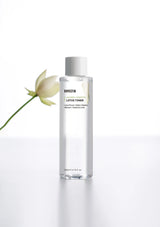 Bottle of Rovectin lotion toner with a white flower on a light gray background