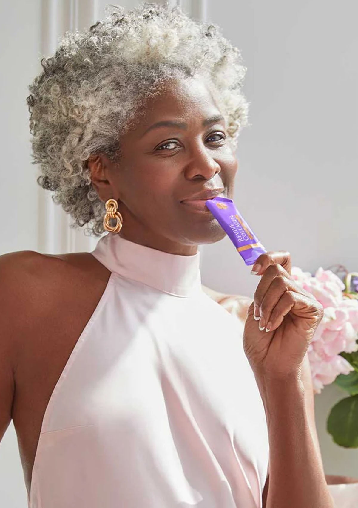 Woman holding a purple product with a white background