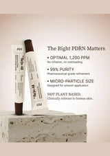 Two skincare products on a stone surface with text about PDRN quality.