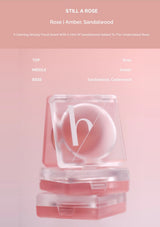 Cosmetic container with a heart design on a pink background, featuring the brand 'h'.