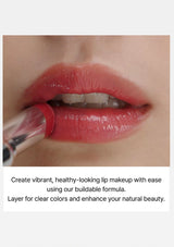 Close-up of a person applying red lipstick with a brush, text about vibrant lip makeup.
