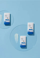 Four skincare product boxes with blue and white design on a light blue background