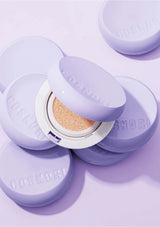Cosmetics with purple lids on a matching purple background
