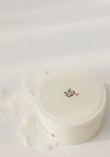 White round container with black text on a light gray background