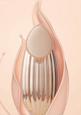 Rose gold and silver makeup tool on a soft pink background