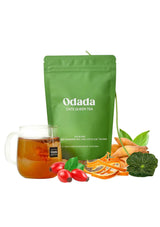 Odada Cate Queen Tea package with a cup of tea, rose hips, and tea leaves on a white background