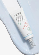 Tube of Aesop Heartleaf My Tye Calming Cream on a light blue background