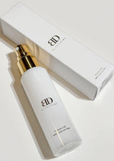 White skincare bottle with gold cap on a light background, featuring the brand 'BD Laboratories'.