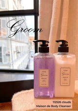 Two bottles of Maison de Body Cleanser by Groom on a surface with a blurred background.