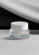 Skincare jar labeled 'Snow' on a gray background