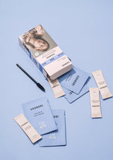 Cosmetics packaging including boxes and packets on a light blue background