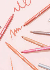 Cosmoti lip pencils on a pink background with visible brand name.