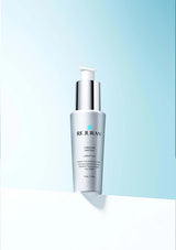 Rejuvenating skincare serum bottle on a gradient blue background