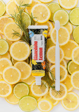 Blistex Blistex Lemon tube surrounded by lemon slices on a white background