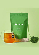 Green Odada tea package with a glass of tea on a light green background