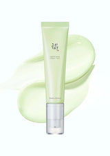 Tube of green skincare product with brand logo on a white background