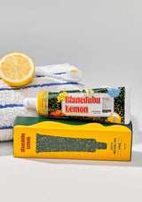Blanchedub Lemon toothpaste tube and packaging on a gray background