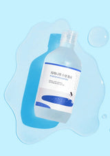 Bottle of skincare product on a blue background