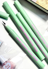 Green eyeliner pencils with pink text on a white background