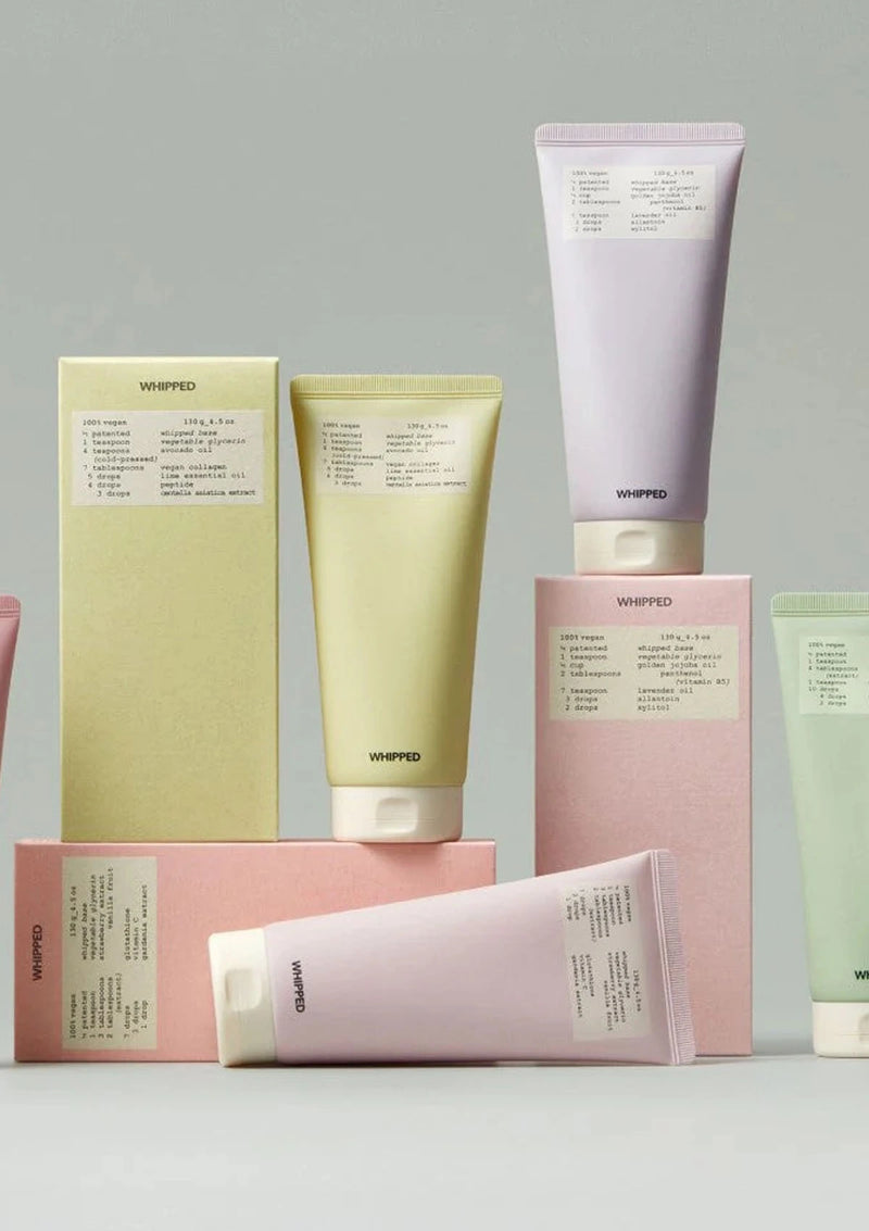 Collection of Whipped skincare products on a light gray background