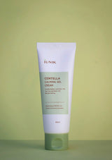 Tube of IUNIK Centella Calming Gel Cream on a green background