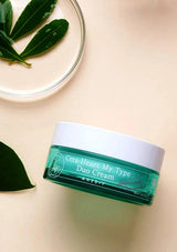 Green jar of 'CeraHeal My Type Duo Cream' on a beige background with leaves.