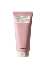 Pink tube of whipped product with a label on a white background