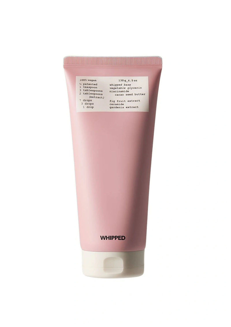 Pink tube of whipped product with a label on a white background