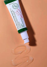 Tube of Axe & Eve Skincare serum on a peach background