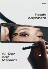 A close-up promotional shot of a hand holding a smartphone mirror while applying false eyelashes with a brush. Text on the image reads 'Aheb', 'Ready Anywhere', and 'All-Day Any-Moment'.