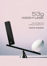 A sleek black rectangular vape device balanced on a geometric scale with a white egg-shaped object, set against a soft pink and lavender gradient background with text reading '53g WEIGHTLESS.' and 'Anytime.