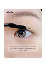 A close-up instructional card showing a person's eye with a black eyelash curling wand applying mascara. The card has the brand name 'Aheb' at the top and text at the bottom explaining the application order.