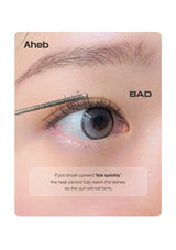 Close-up of a person's eye with a spoolie-style eyelash tool touching the lashes, plus text reading 'Aheb', 'BAD', and a caution note about brushing upward too quickly.