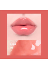 Close-up of glossy pink lips with 'Geek 245' text on a peach background