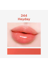 Close-up of glossy pink lips with '244 Heyday' text on a white background