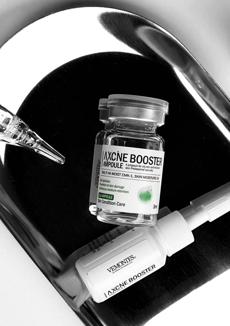 Vaccine booster ampoule and syringe on a black background